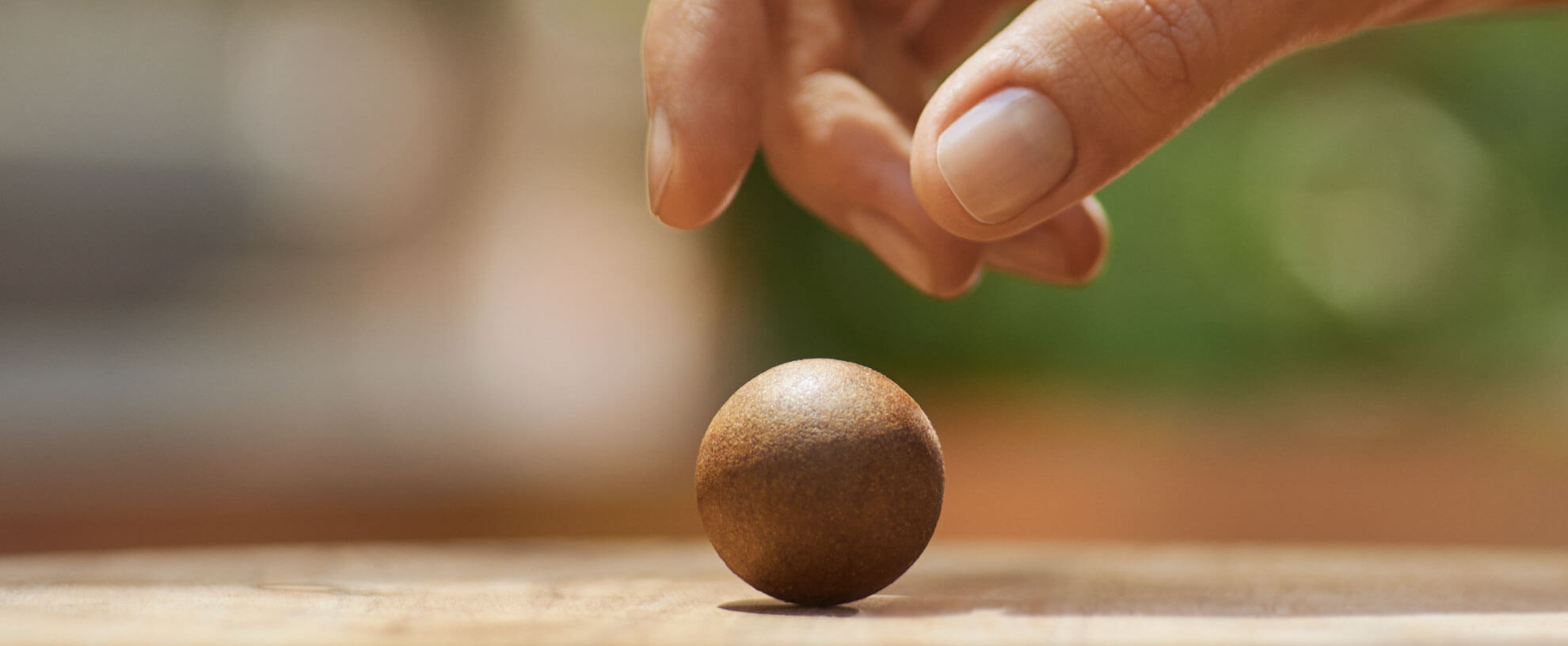 Eine Hand greift nach einer Coffee Ball Kaffeekugel